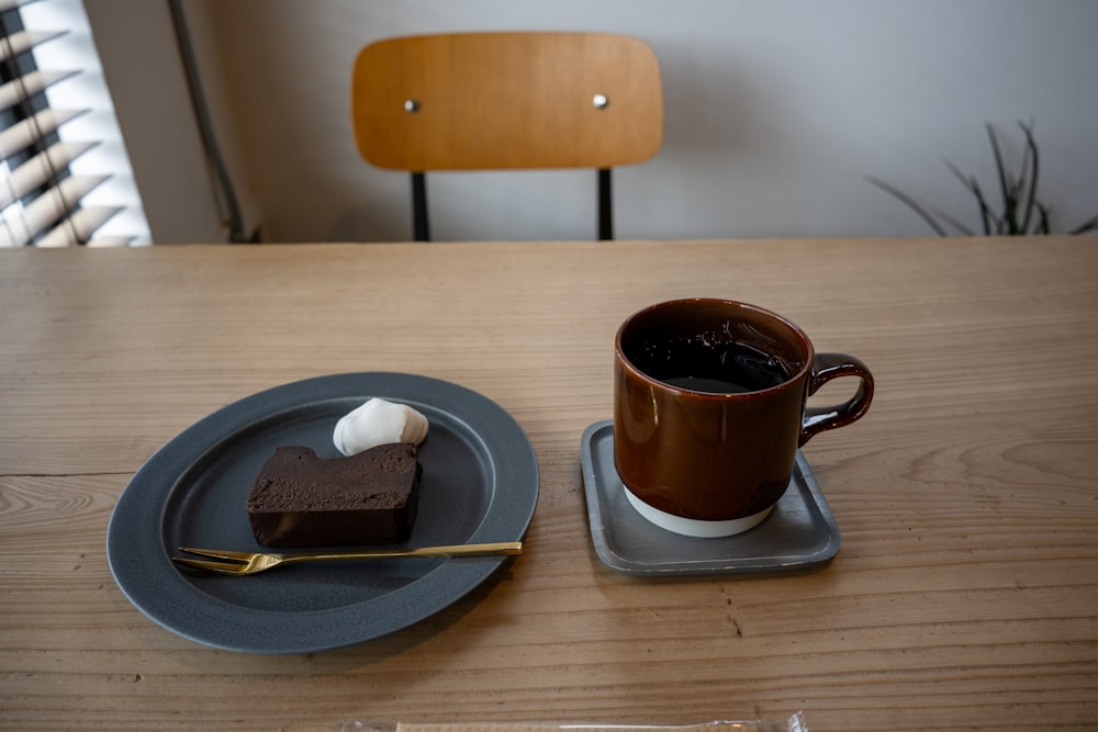 a plate with a piece of cake and a cup of coffee