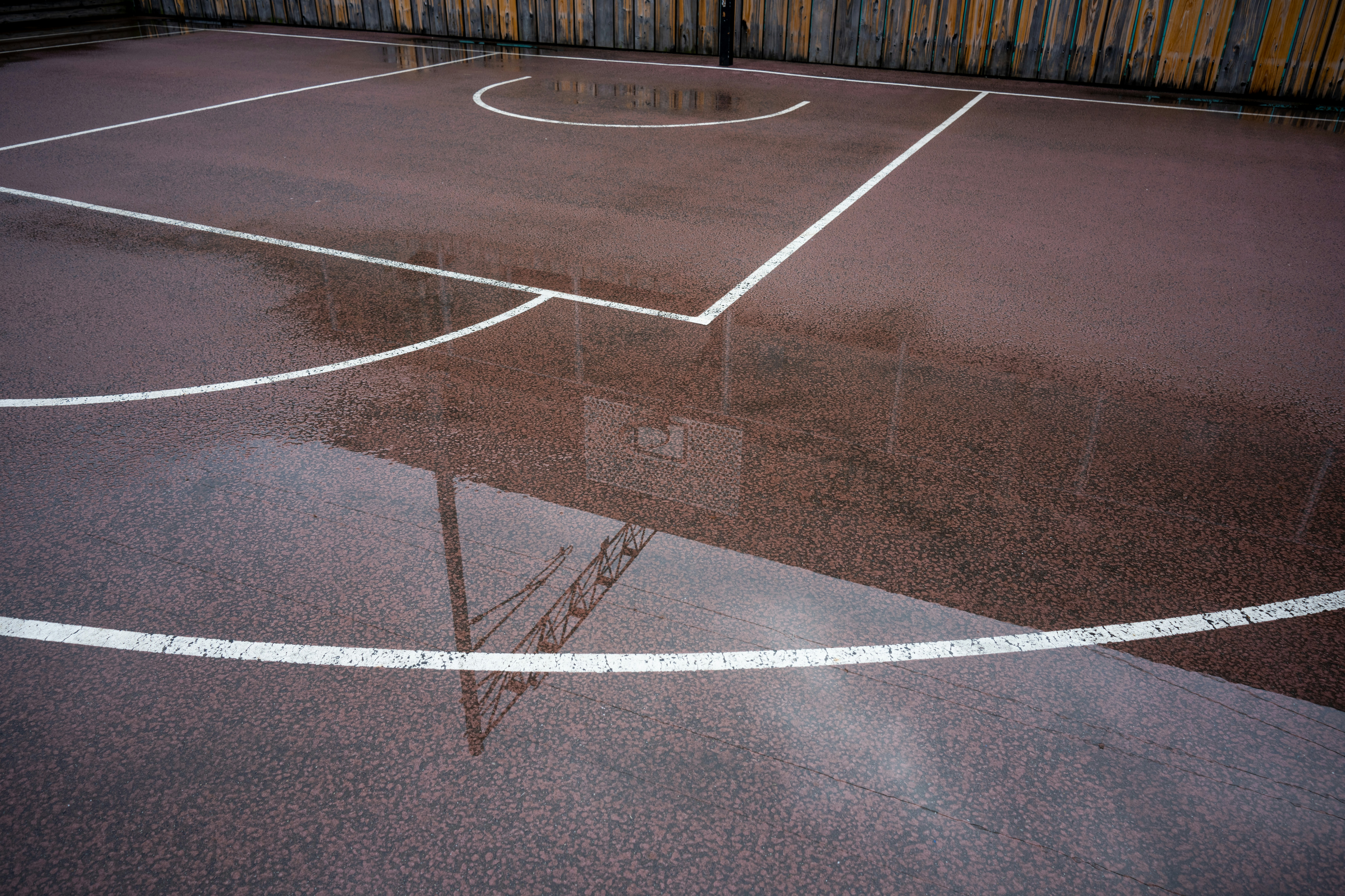 warped hardwood court boards after water exposure