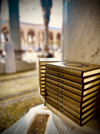 a stack of books sitting on top of a table