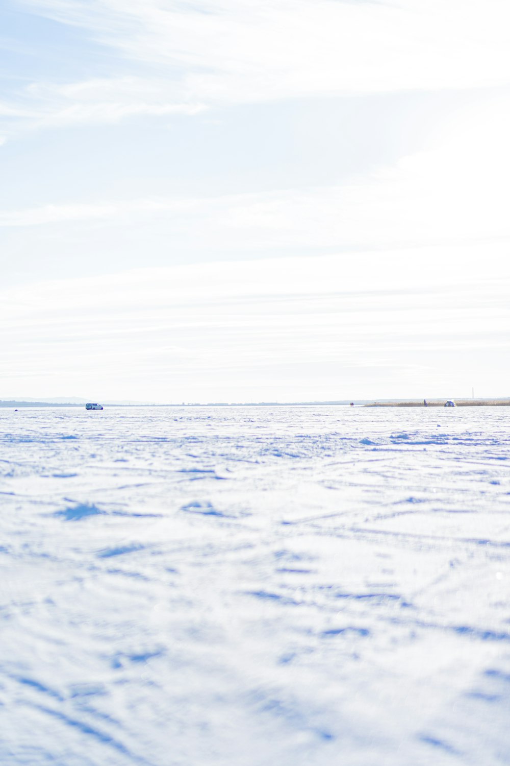 a person walking across a snow covered field