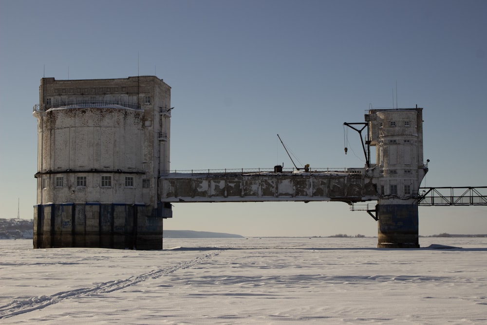 a bridge over a frozen river with a building on top of it