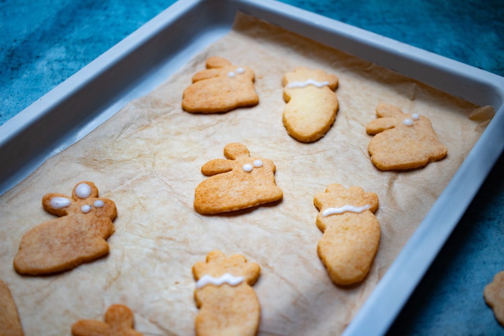 a tray of cookies decorated with white icing