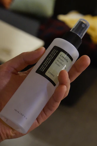 a person holding a bottle of alcohol in their hand