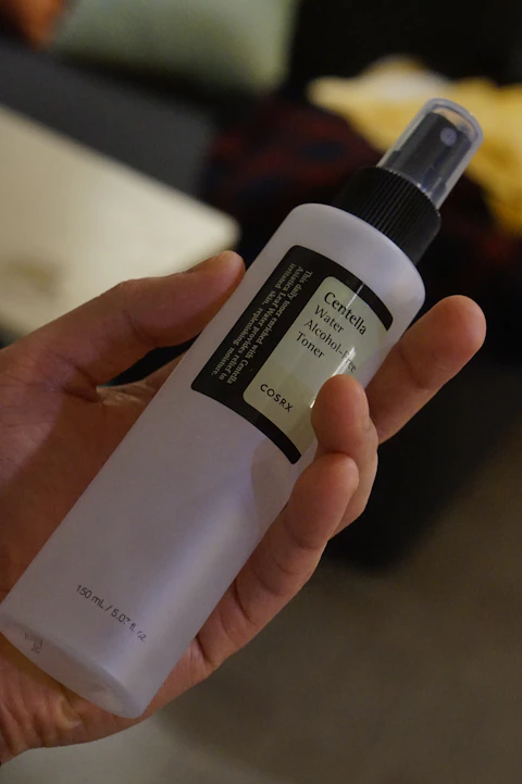 a person holding a bottle of alcohol in their hand