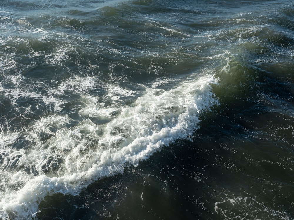 a large body of water with a wave coming in