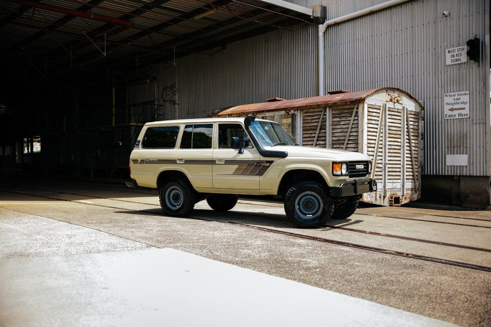 a white suv parked in front of a building