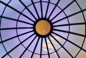 a close up of a glass roof with a yellow light
