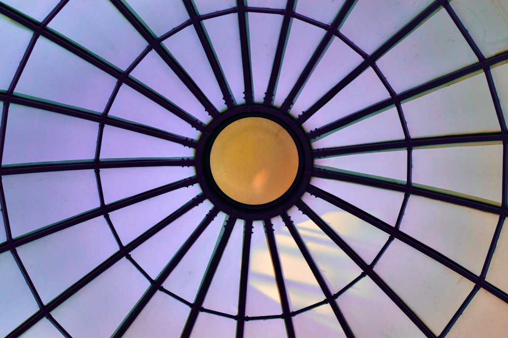 a close up of a glass roof with a yellow light