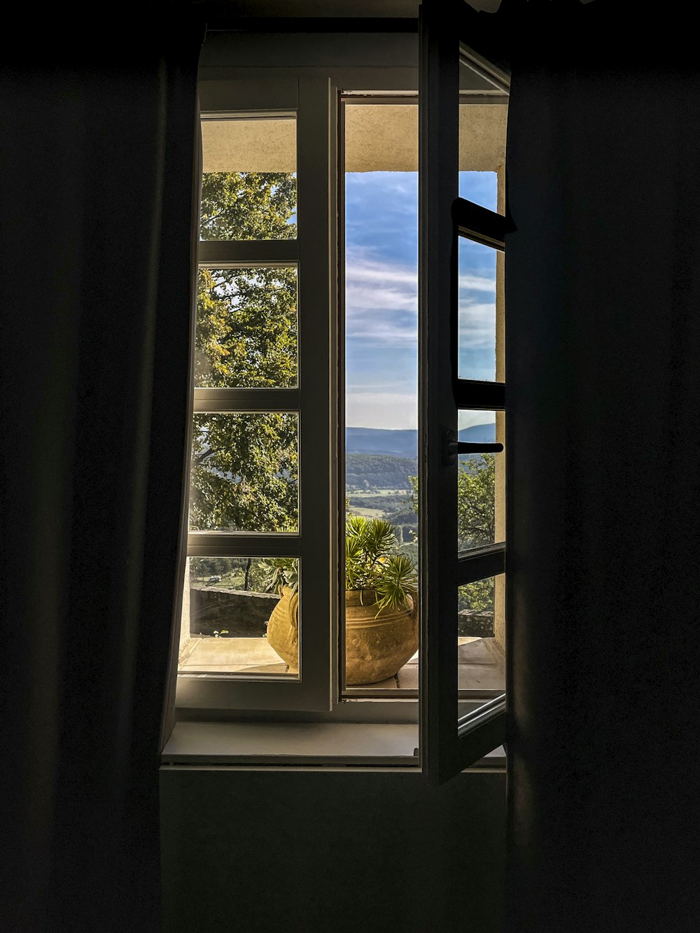 a window with a view of a mountain