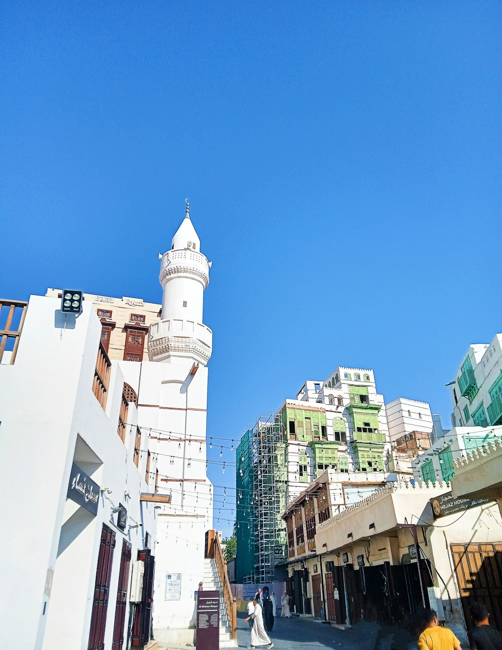 a tall white building sitting next to a tall white building