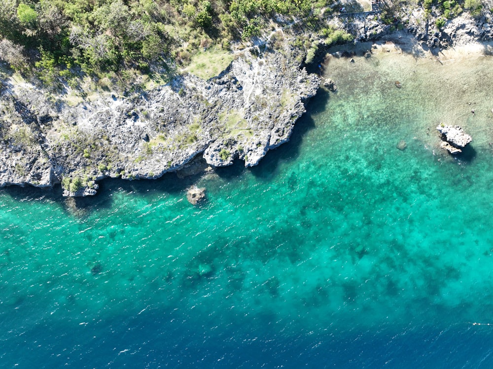 an aerial view of a body of water with a boat in it