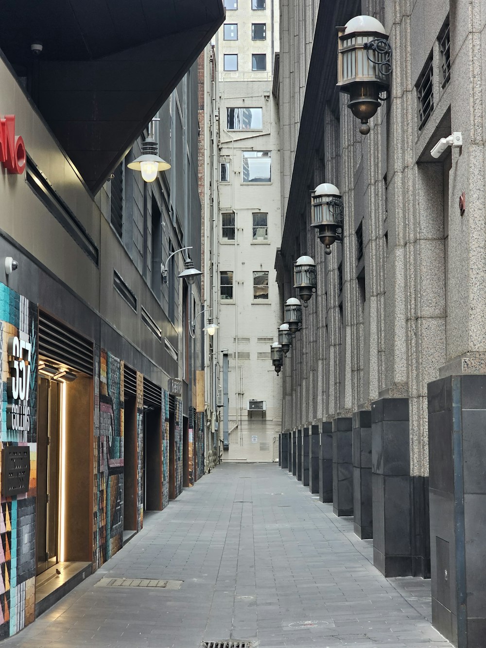 a city street with a row of tall buildings