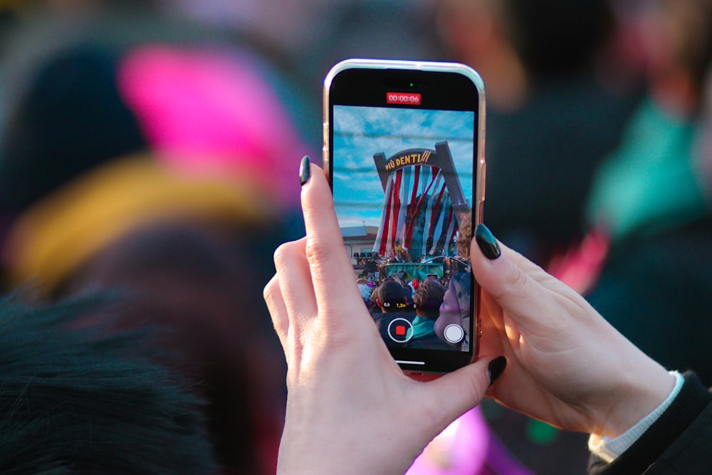 a person taking a picture with a cell phone