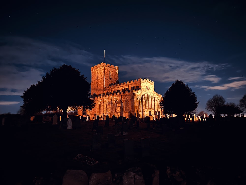 a church lit up at night with a sky background