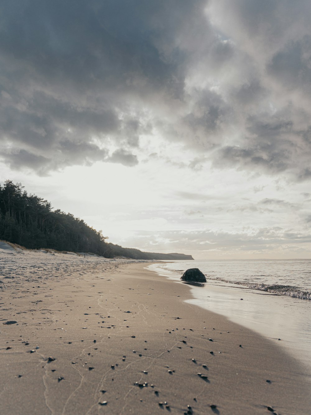 a sandy beach with footprints in the sand