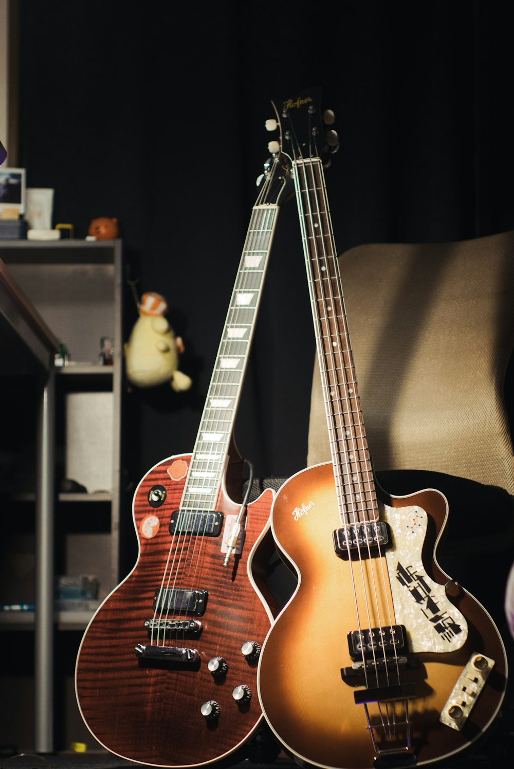 two guitars sitting next to each other on a table