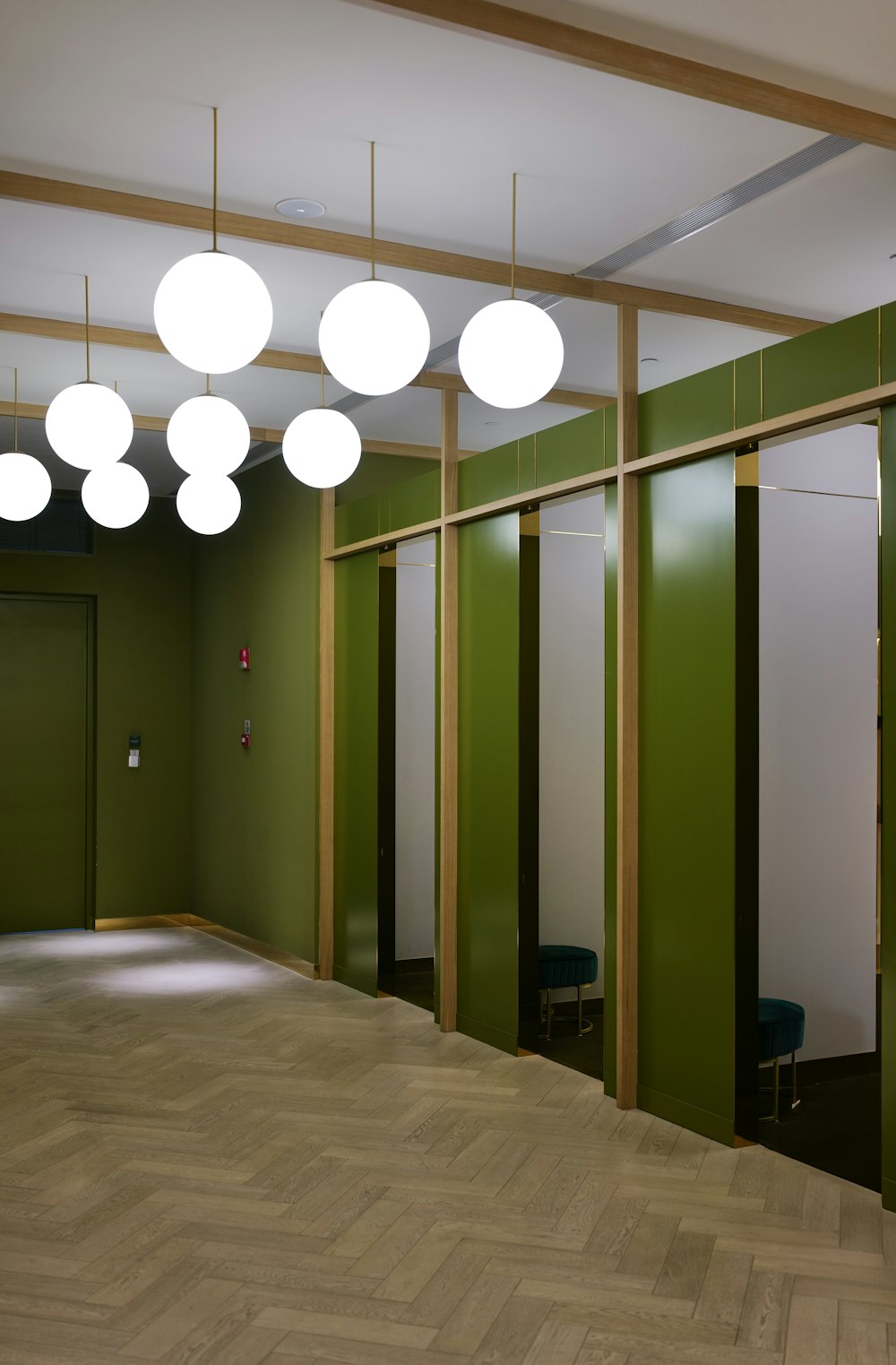 a room with green walls and white lights