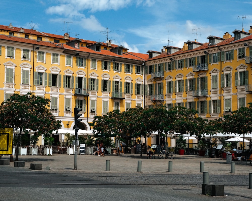 a large yellow building with many windows and balconies