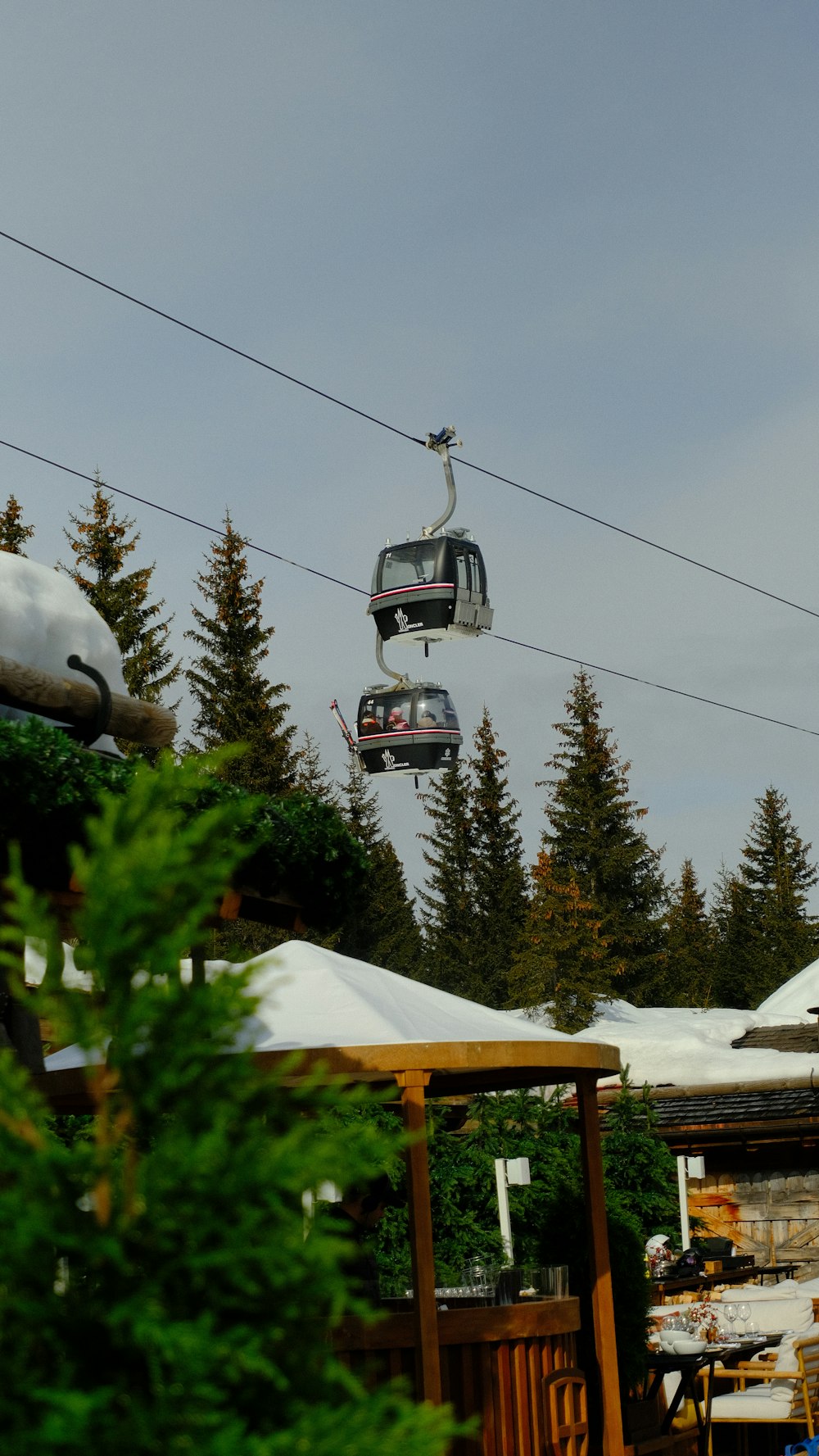 a ski lift going over a snow covered mountain
