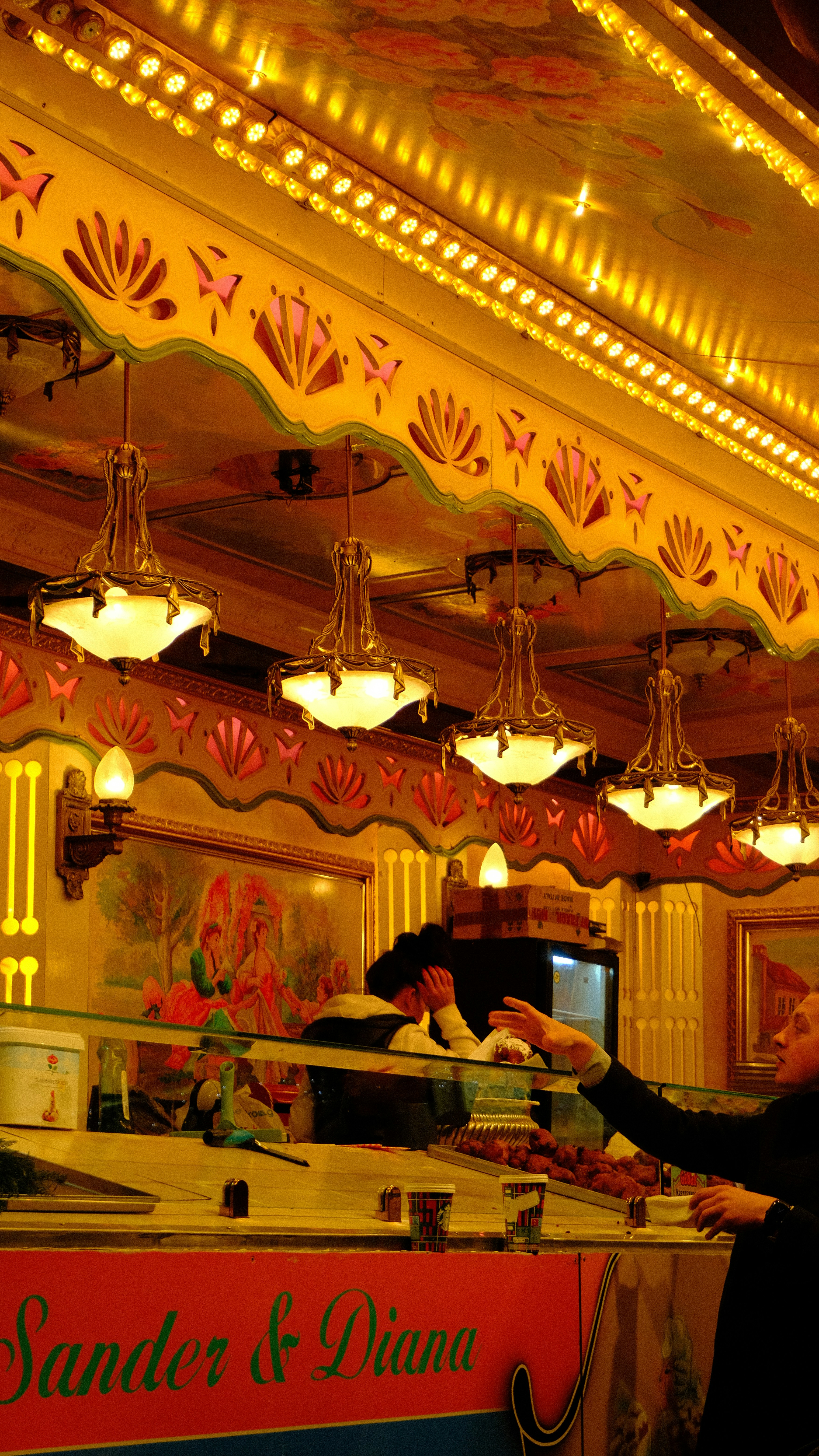 a woman standing in front of a counter in a restaurant