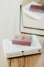 a couple of books sitting on top of a wooden table