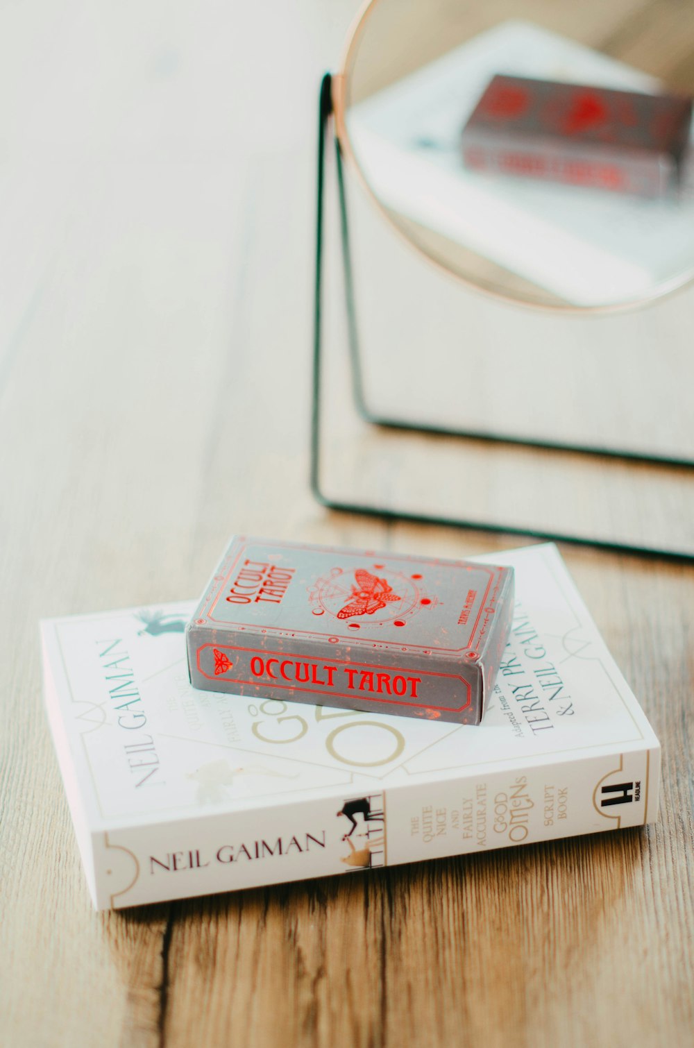 a couple of books sitting on top of a wooden table