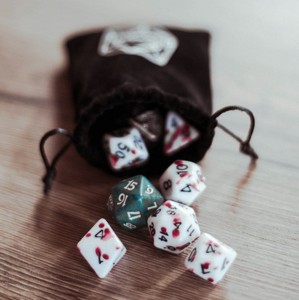 a dice bag with dices in it sitting on a table