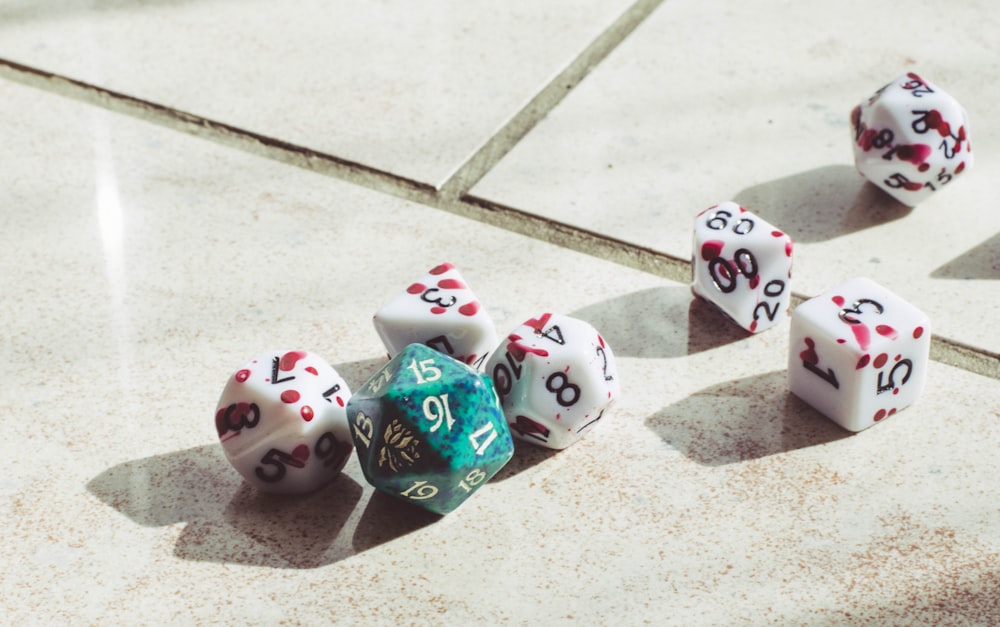 a group of dices sitting on top of a cement floor