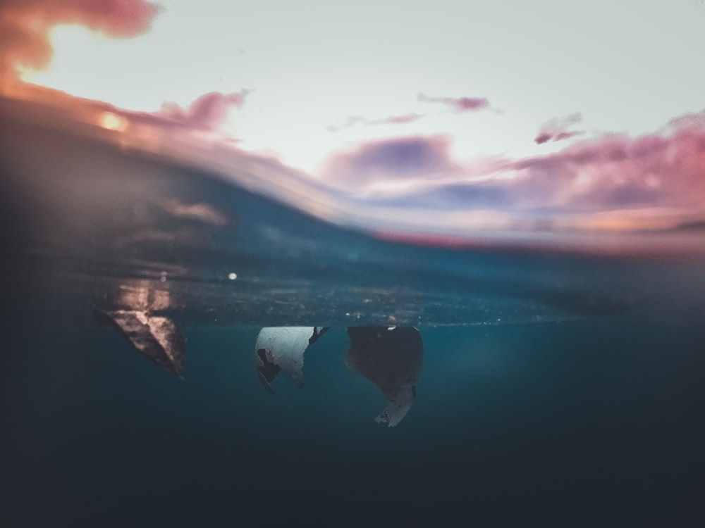 a couple of boats floating on top of a body of water