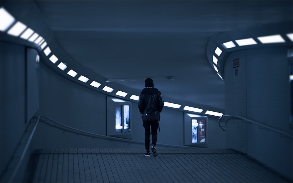 a person walking down a hallway in a building