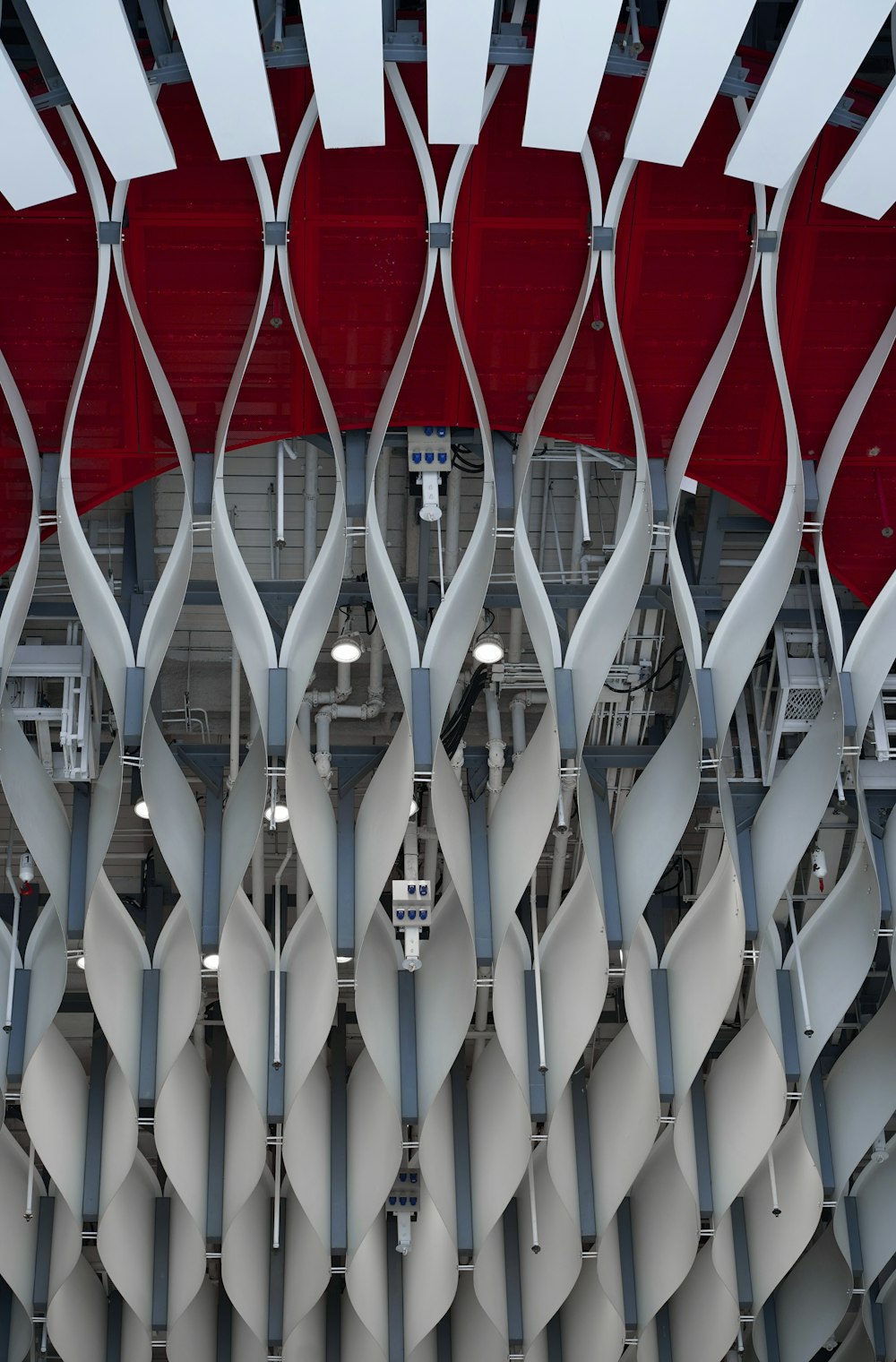 a large metal structure with red and white chairs