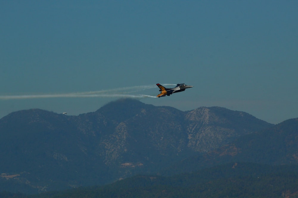 a plane is flying over a mountain range