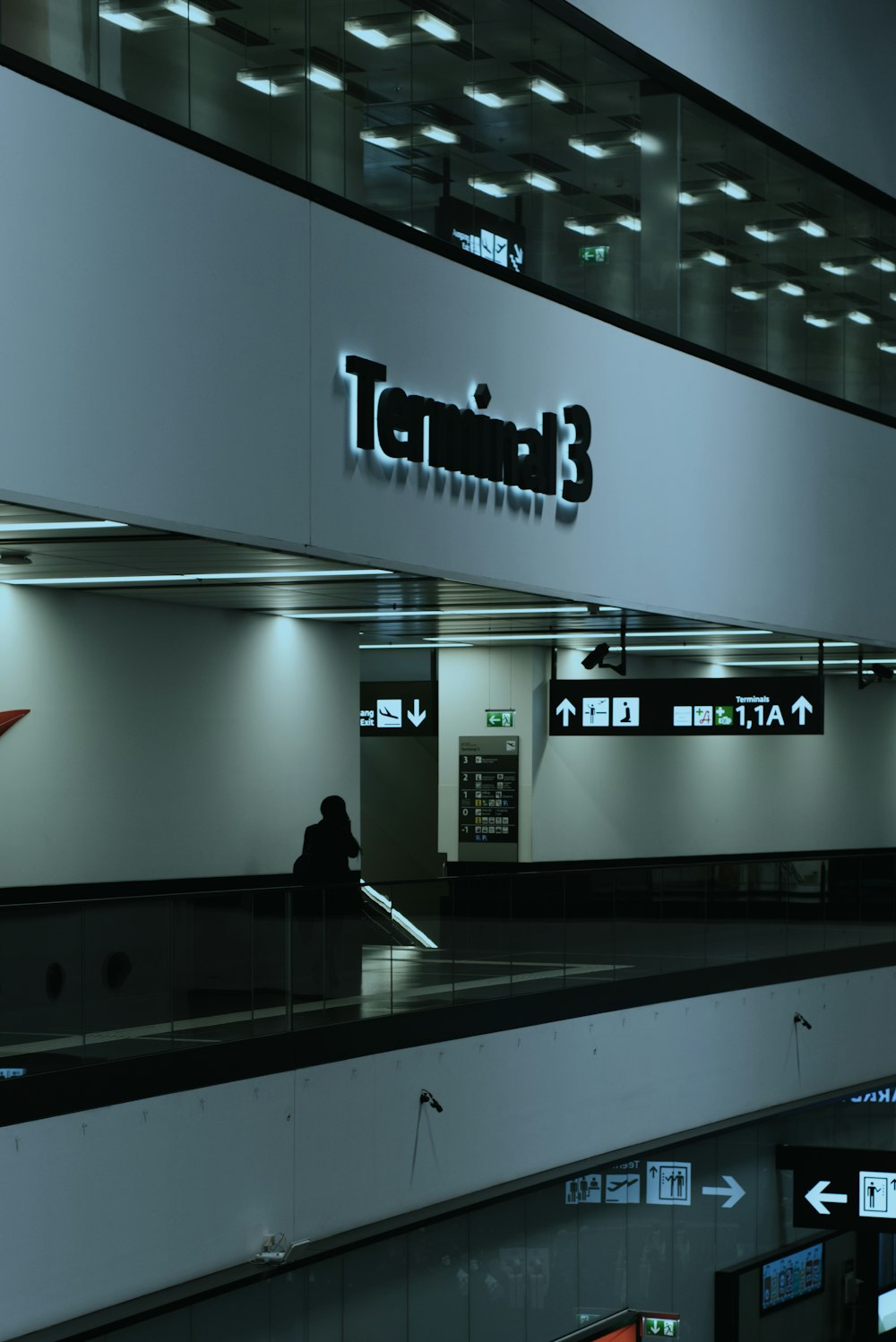 a person sitting on an escalator in an airport