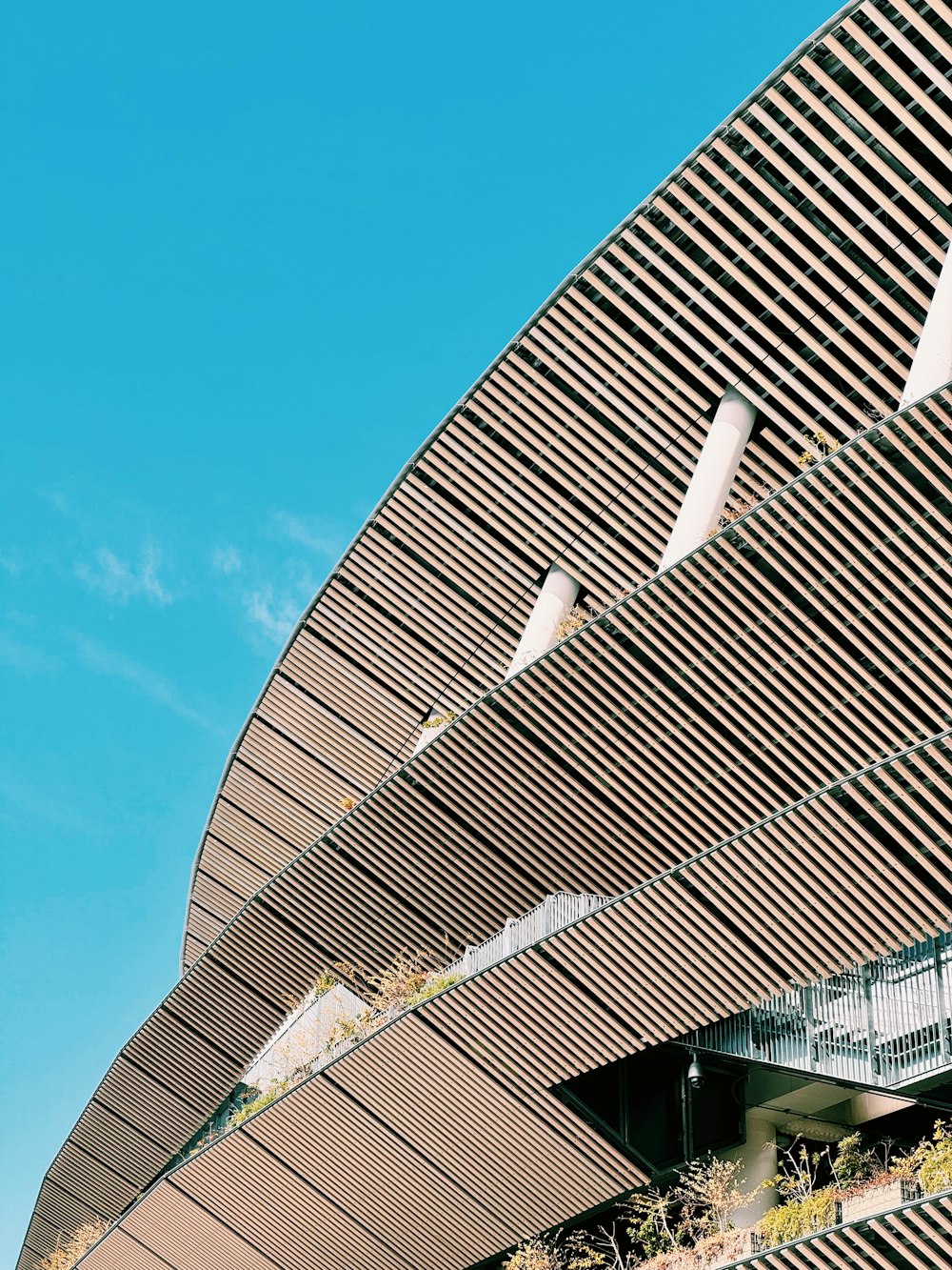 a bird flying over a building with a sky background