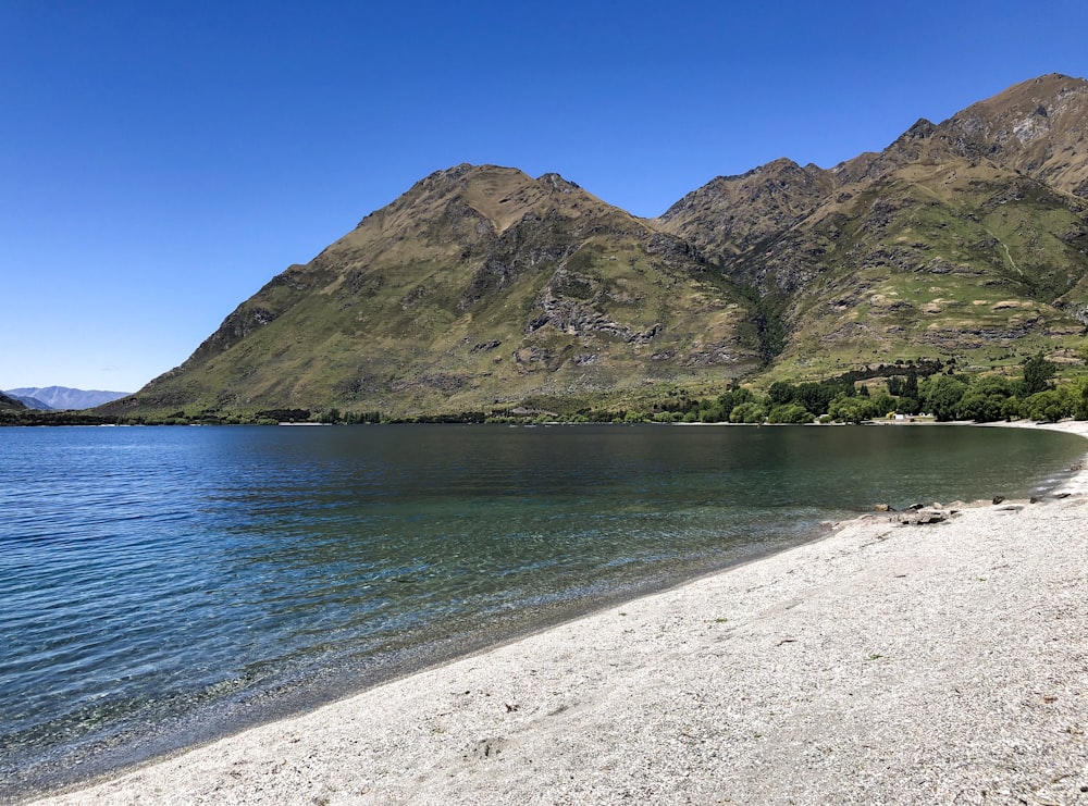 a beach with a mountain range in the background