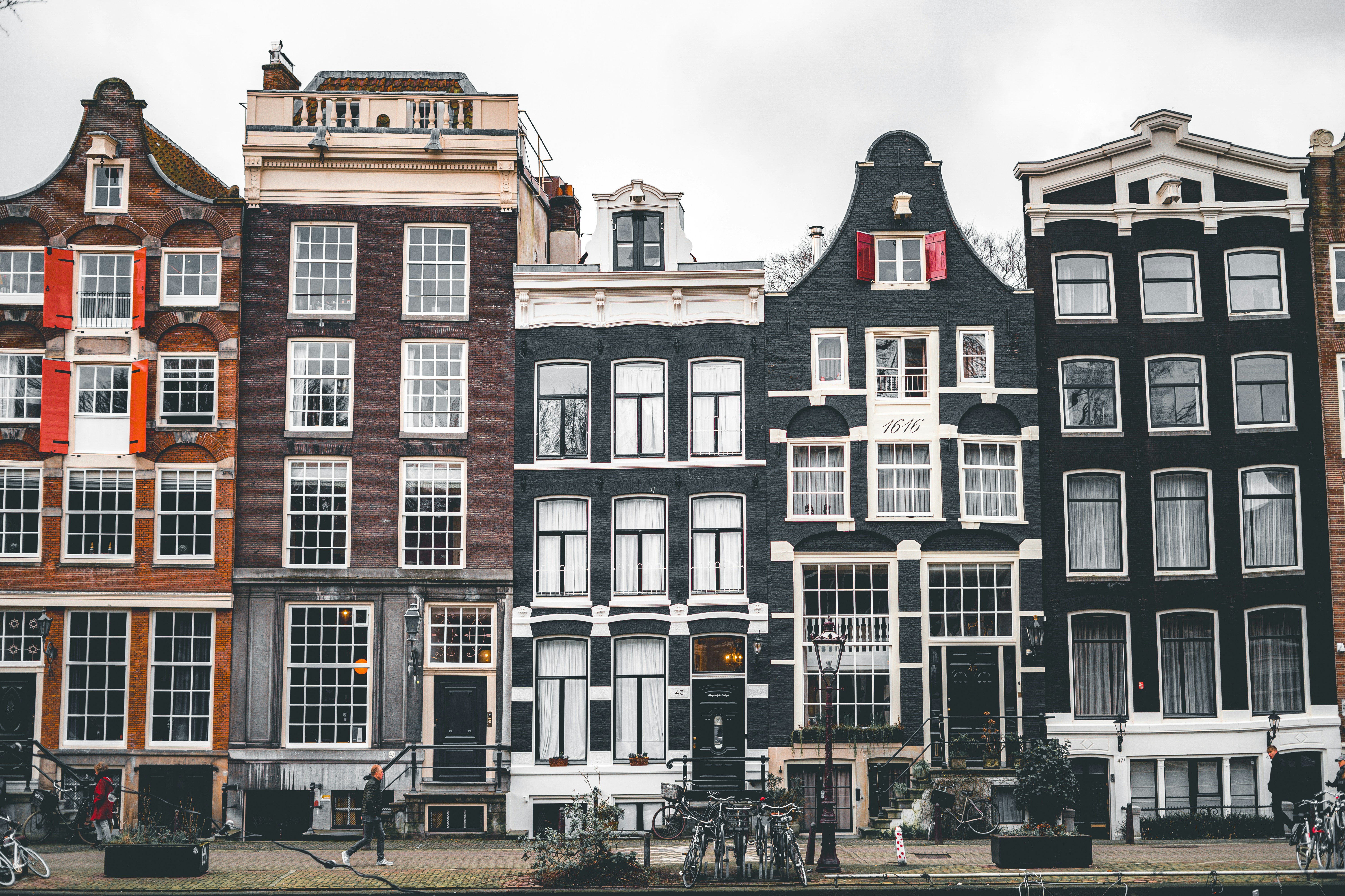 a row of buildings with bicycles parked in front of them