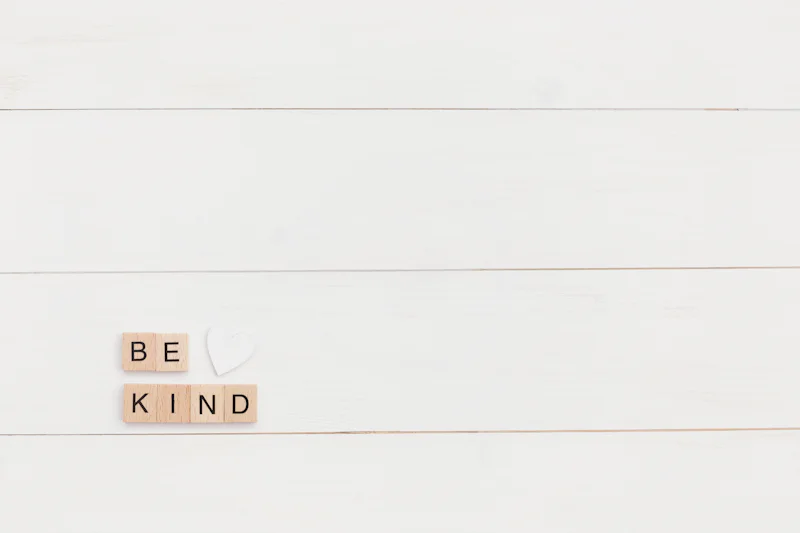 Wooden letter tiles spelling the words be kind