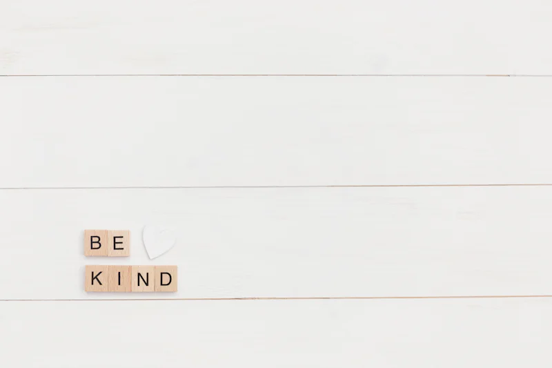 Wooden letter tiles spelling the words be kind