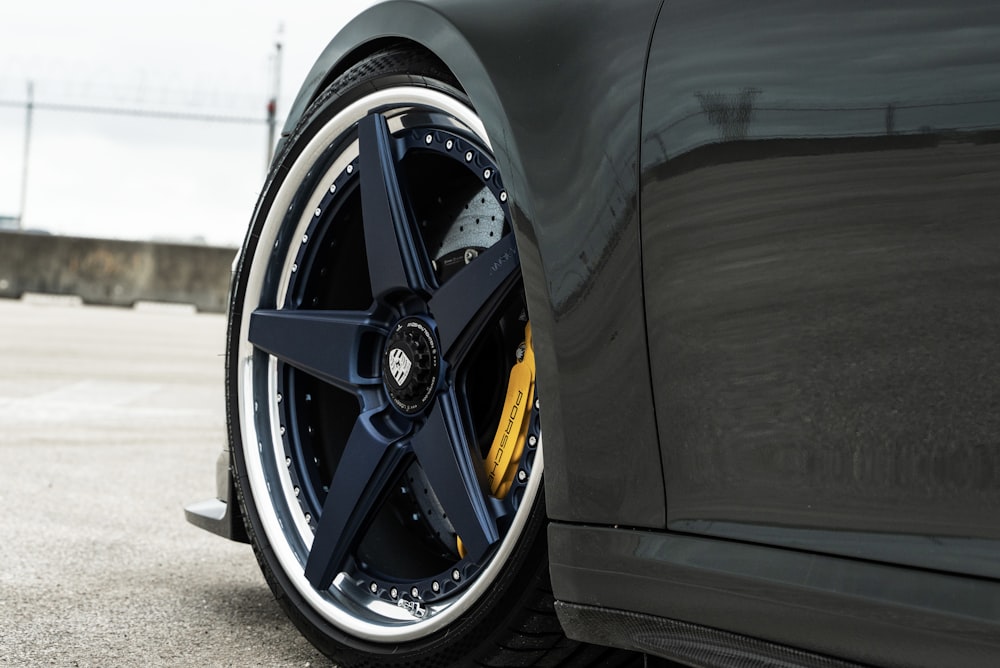 a close up of a car tire on a parking lot