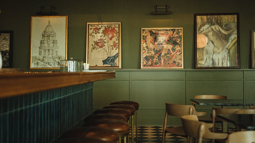 a restaurant with green walls and pictures on the wall