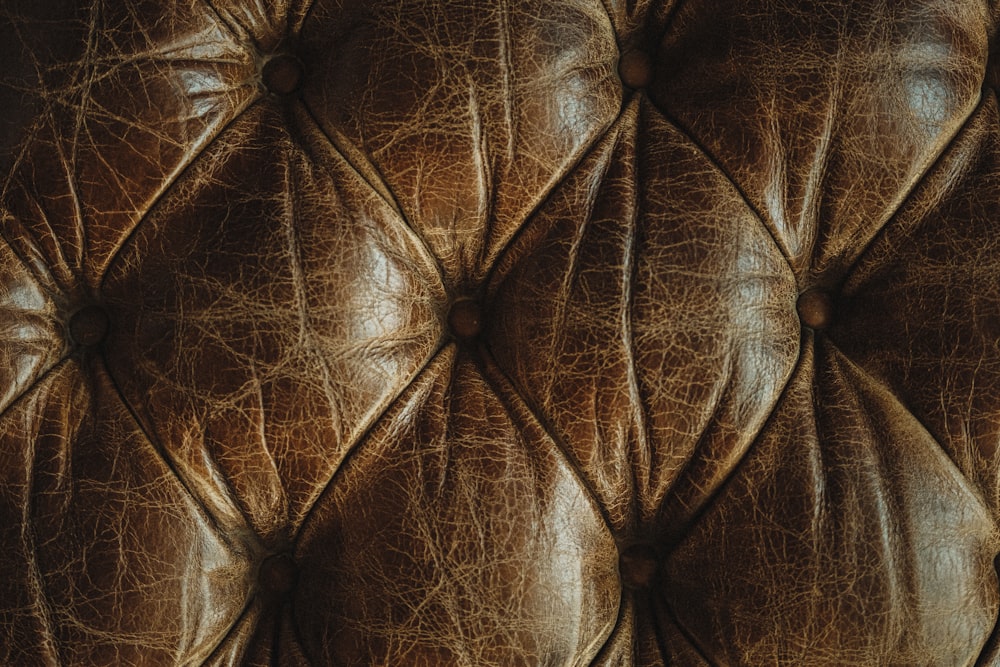 a close up of a brown leather upholster