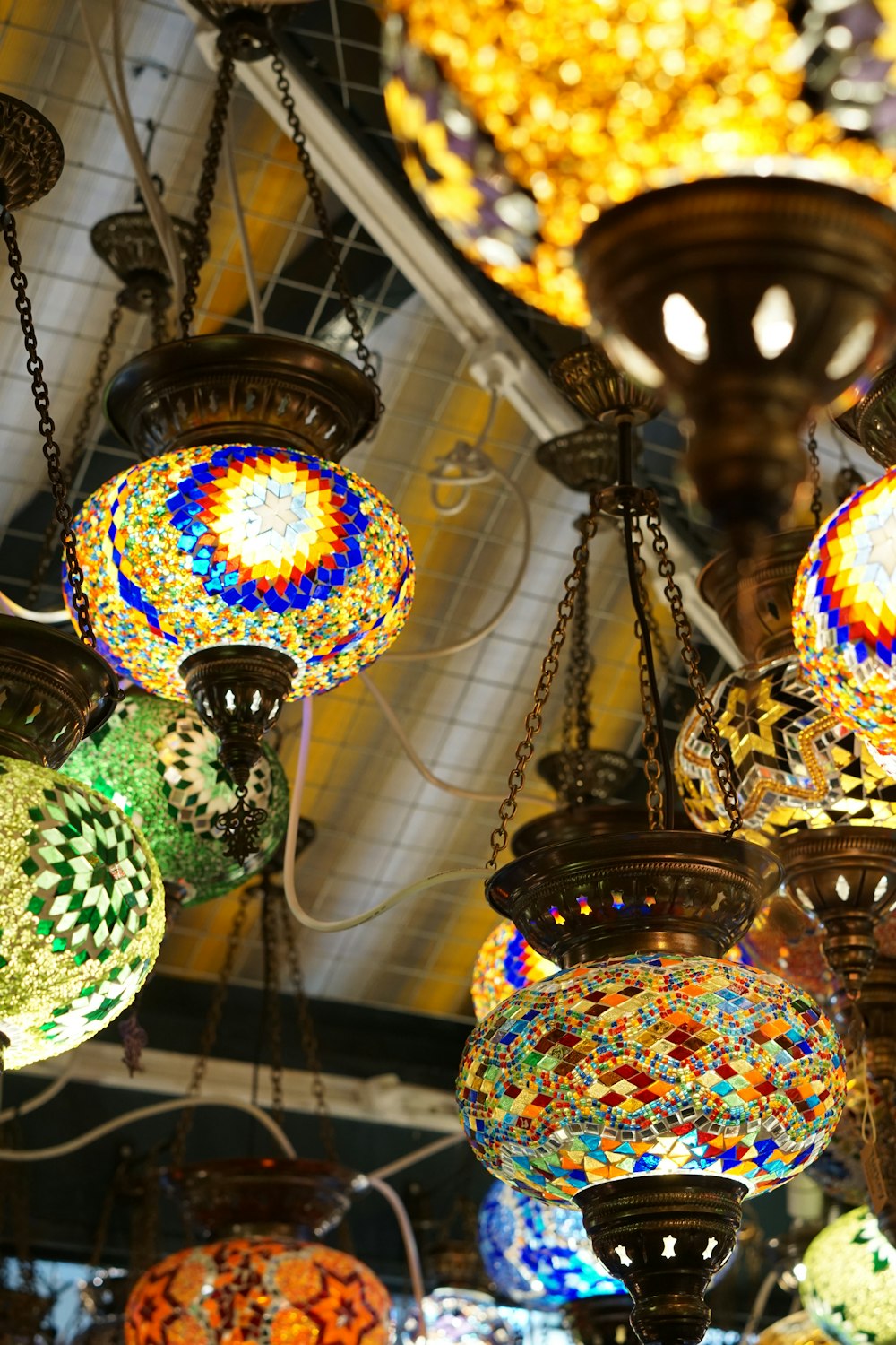 a bunch of colorful lights hanging from a ceiling