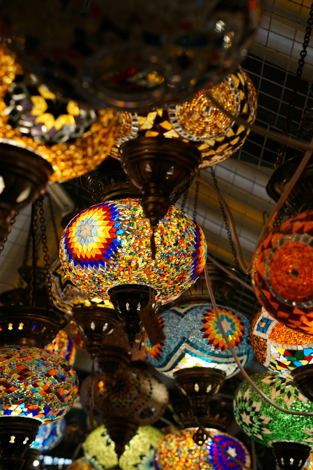 a chandelier hanging from a ceiling filled with lots of colorful lights