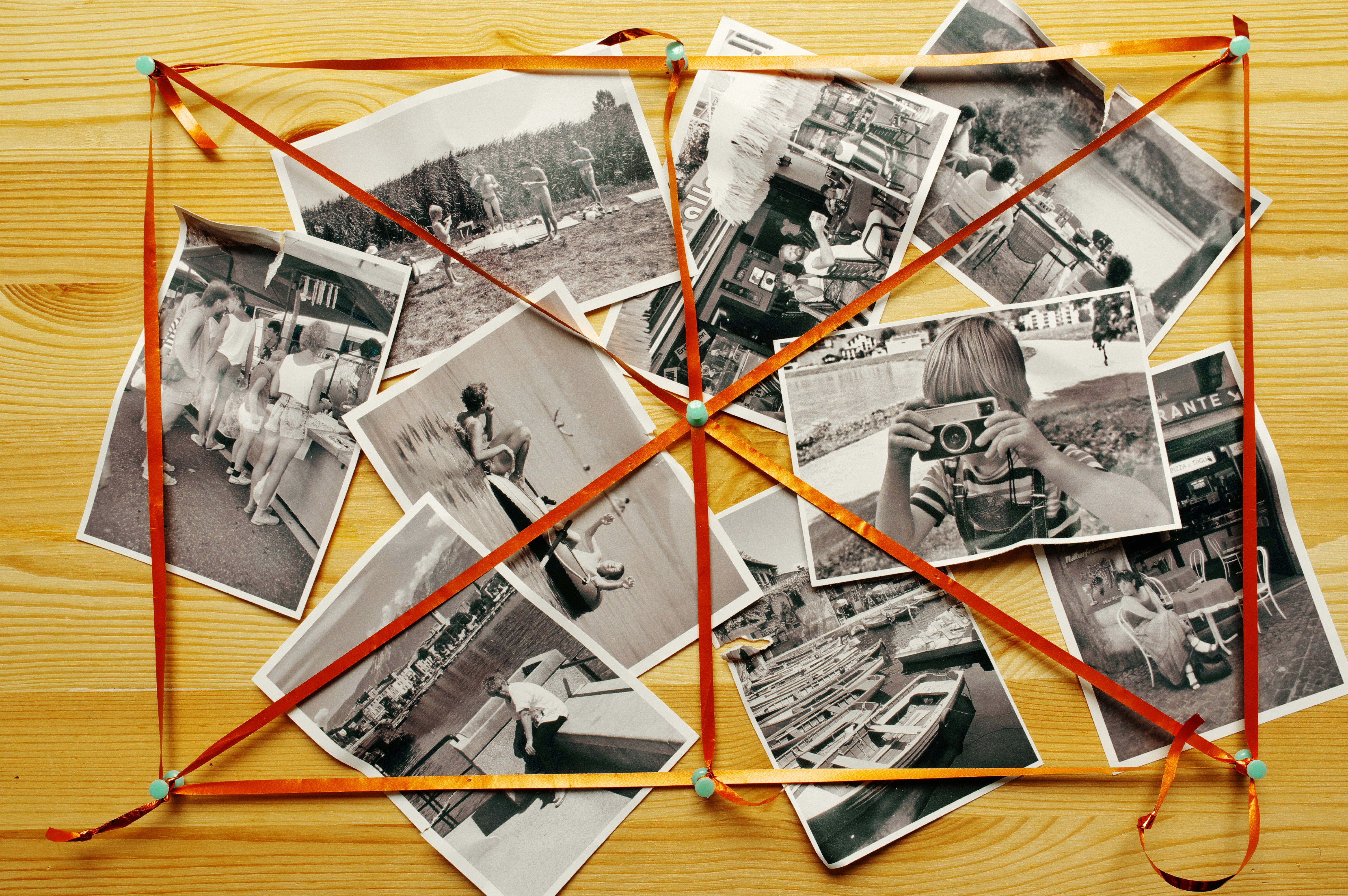 A collection of black and white photos on a pinboard
