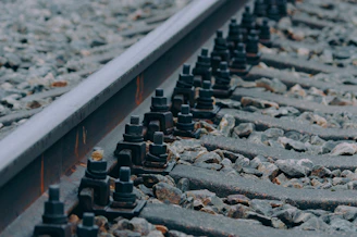 a close up of a train track with rocks and gravel
