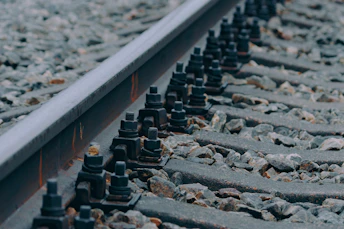 a close up of a train track with rocks and gravel