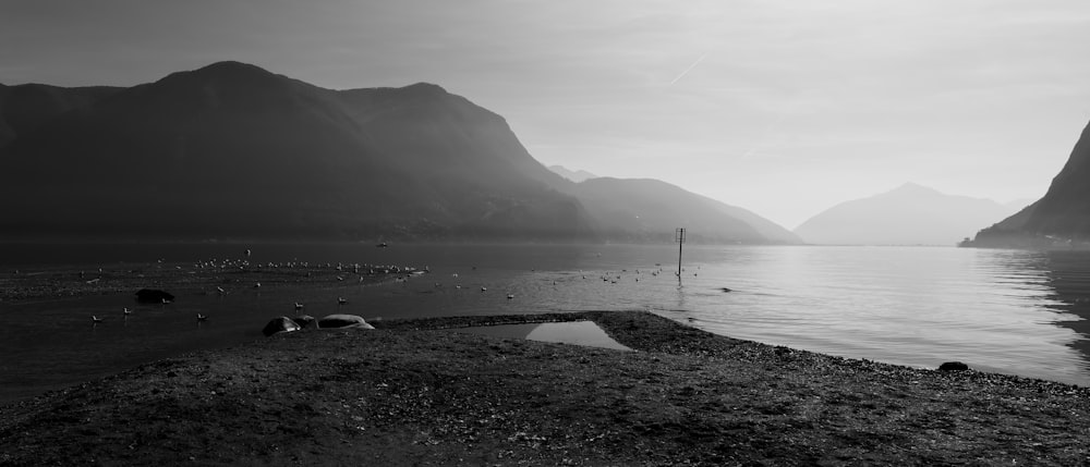 a body of water with mountains in the background