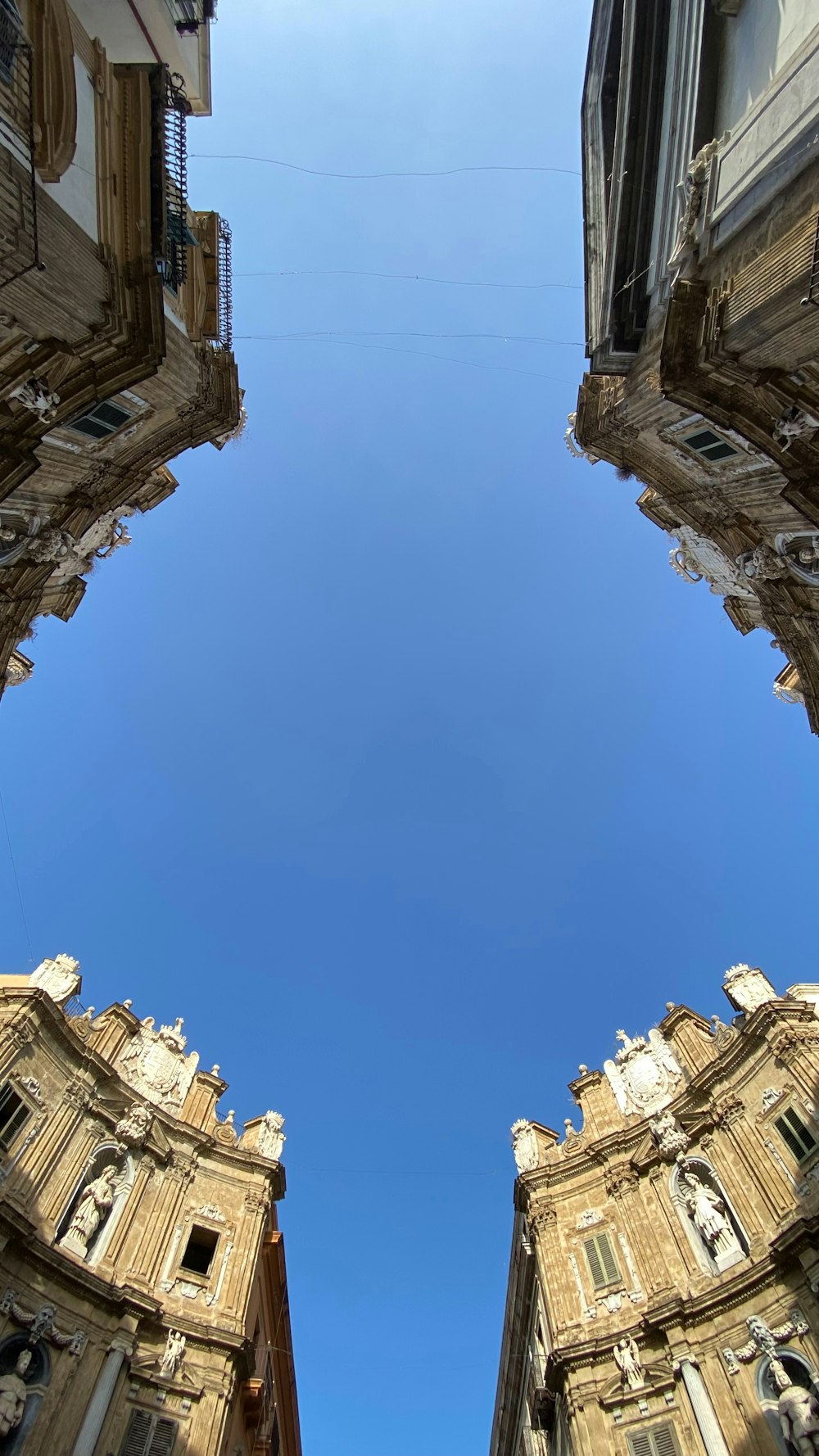 looking up at a tall building with a blue sky in the background