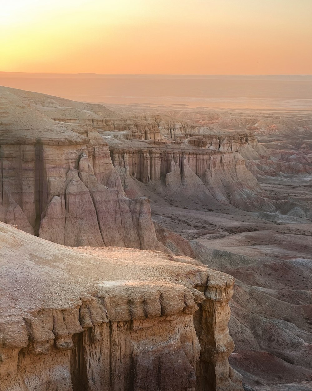 the sun is setting over the canyons in the desert