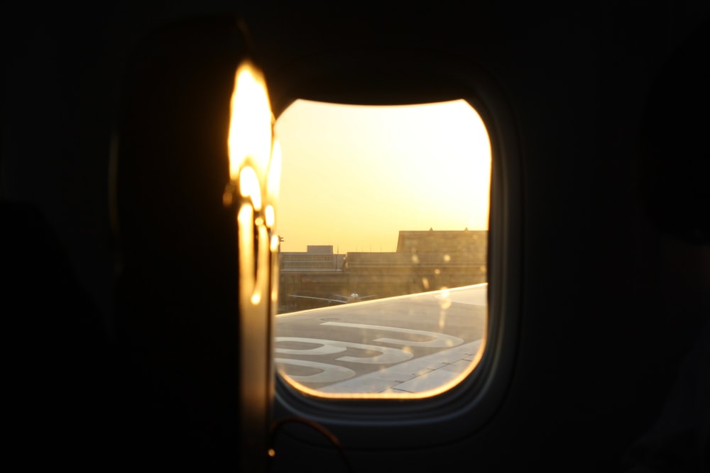 an airplane window with a view of a city